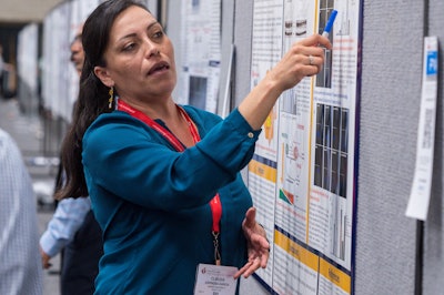 Person pointing to information on a poster