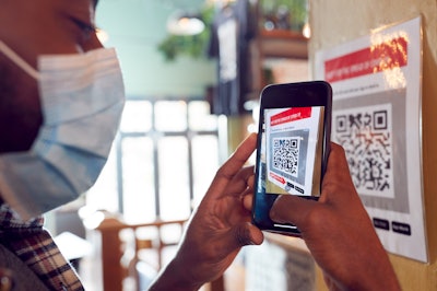 Man scanning a QR code with a mobile phone
