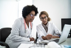 Two doctors viewing online programming