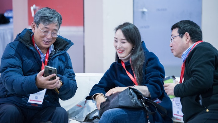 Man showing something to others on his cell phone