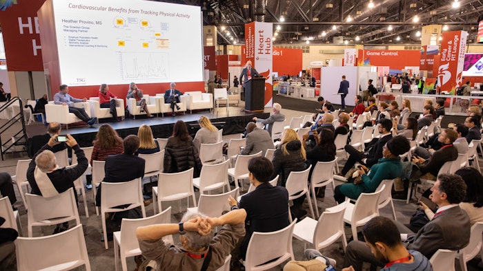 Crowd watching a presentation on a stage.