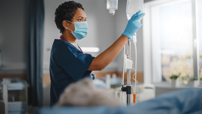 med tech checking fluids in a hospital