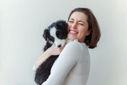 woman snuggling a puppy