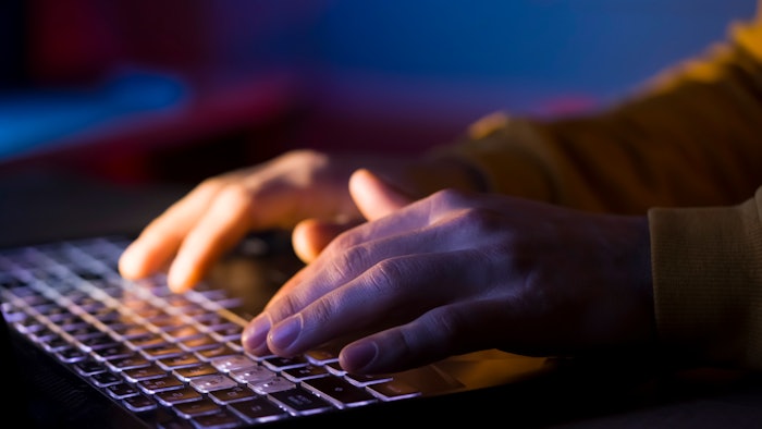 hands on laptop keyboard