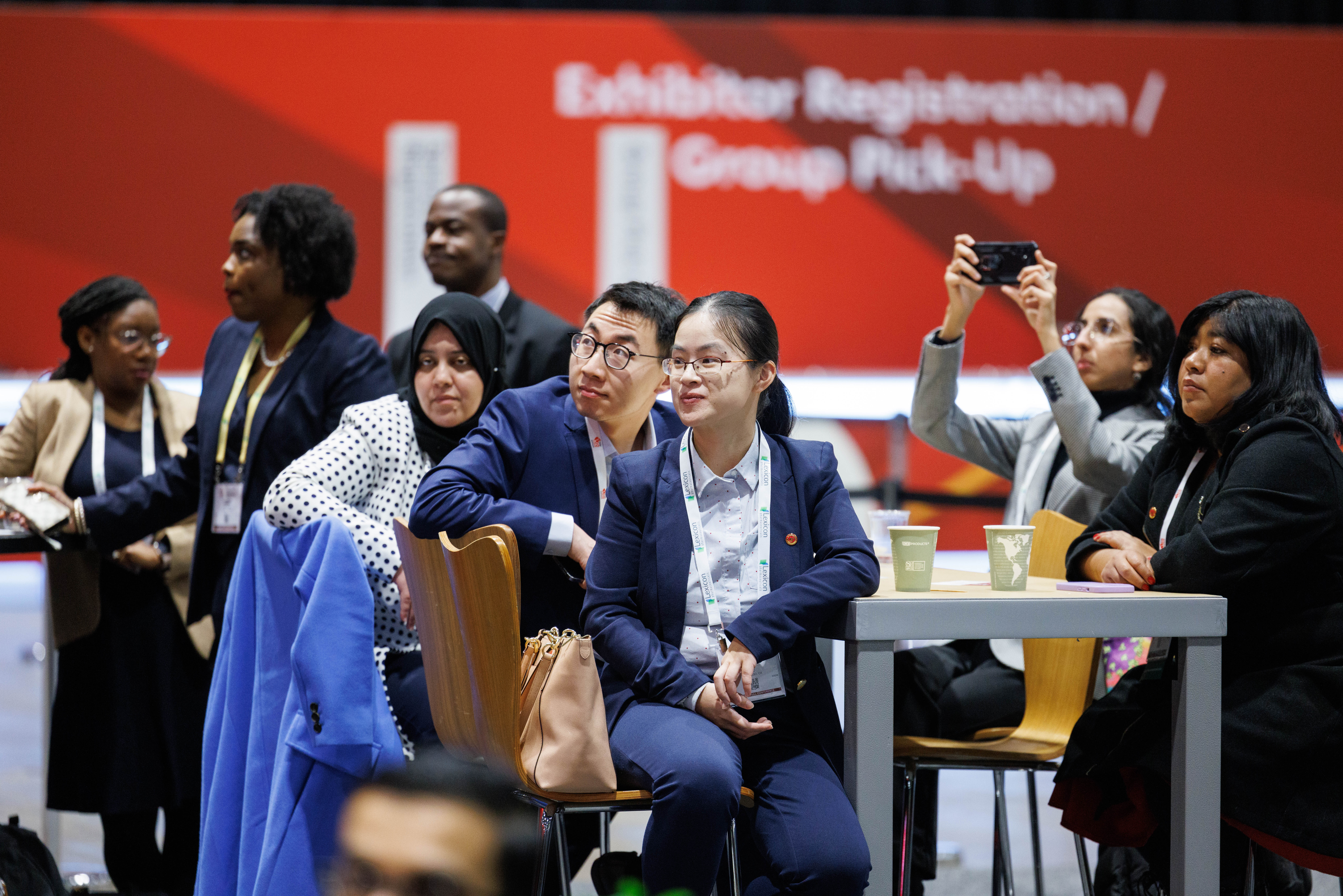 Diverse group of professionals gathered at conference registration area