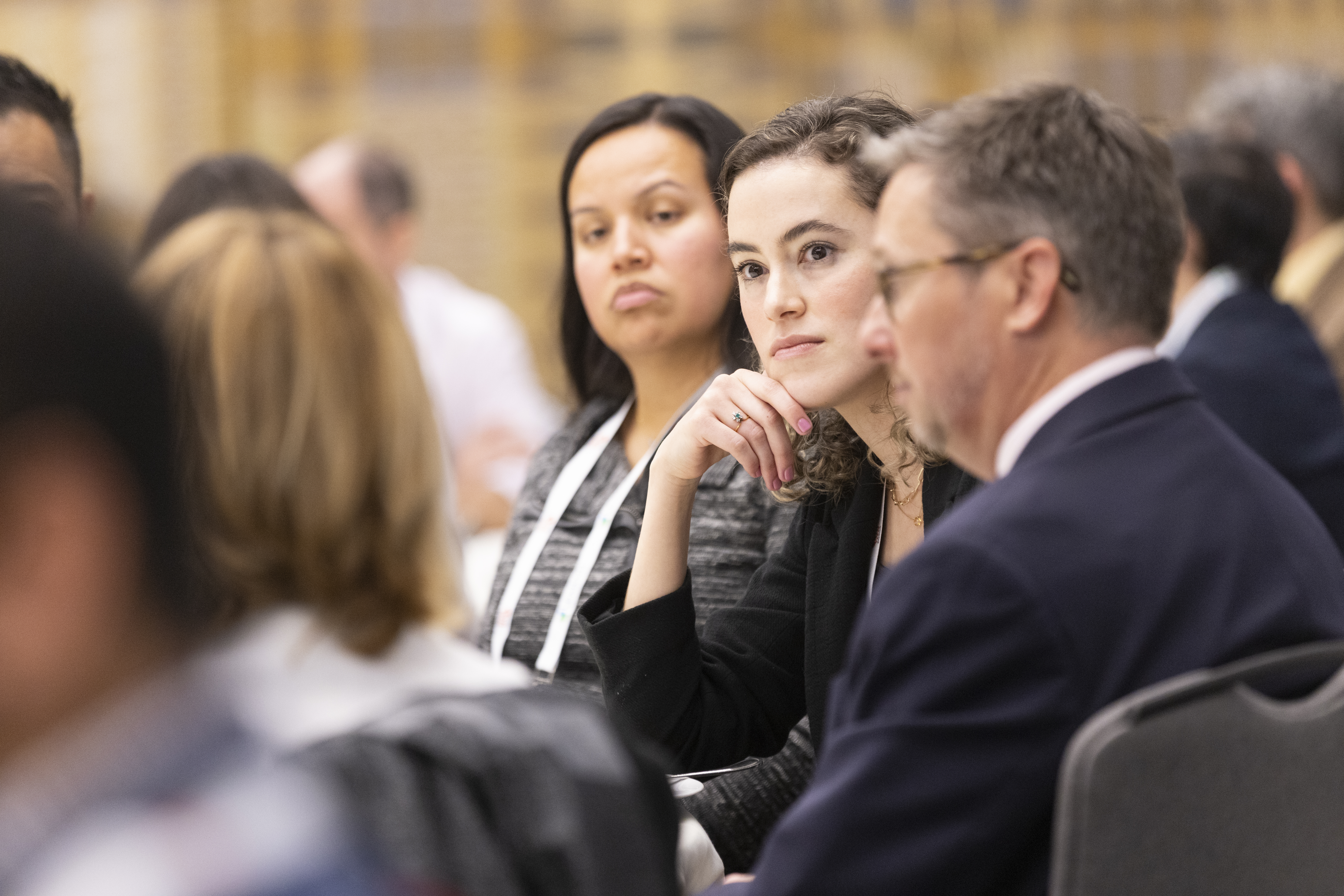 Professionals listening attentively during a business conference meeting