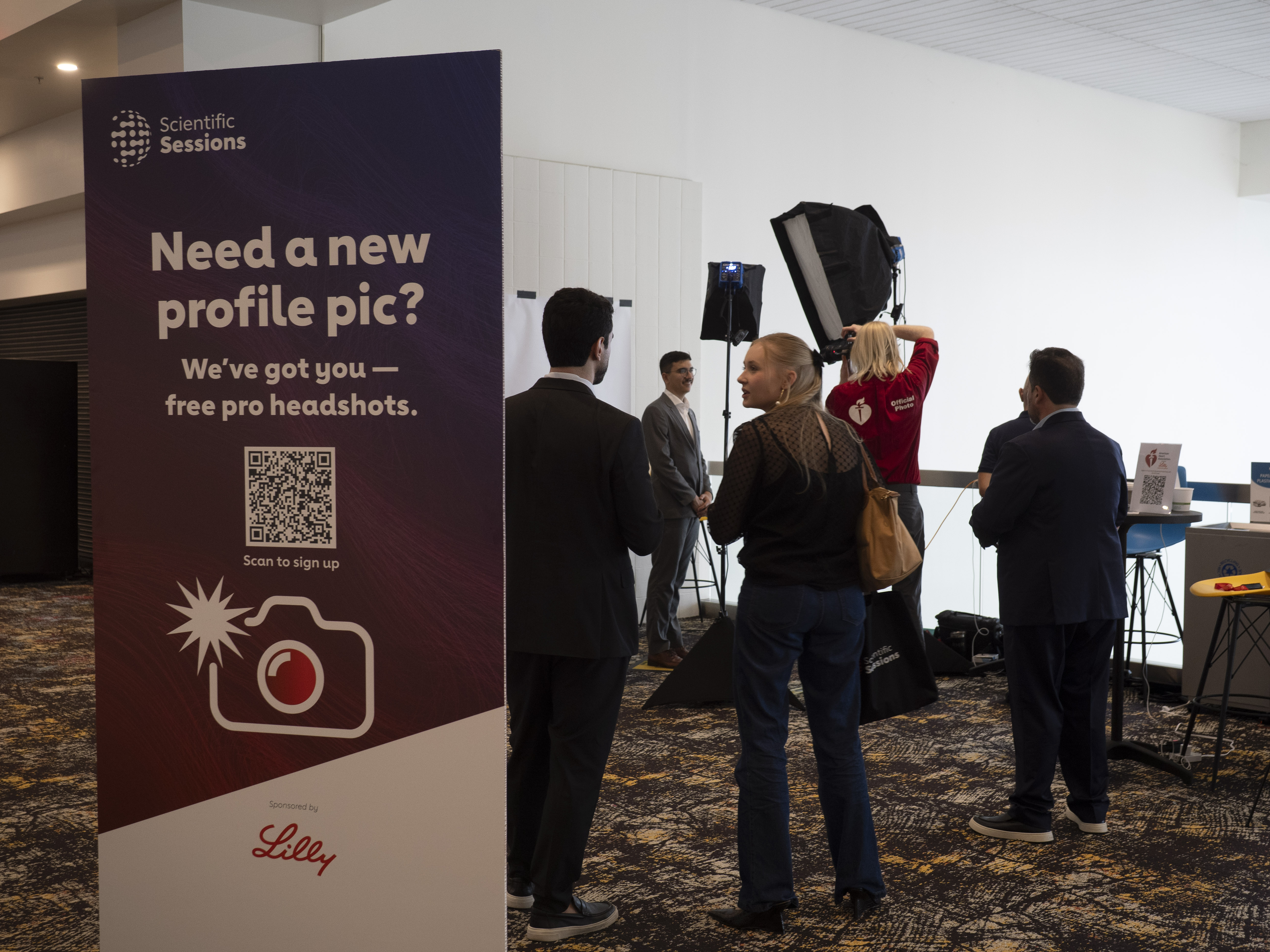 Professional headshot photography station at Scientific Sessions conference event with promotional banner offering free pro headshots