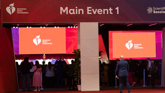 American Heart Association Main Event 1 conference presentation with large display screens showing the AHA logo and audience members in an auditorium setting.