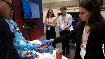 Professionals demonstrate interactive relaxation zone at conference exhibition with attendees wearing badges