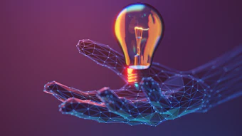 Digital illustration of a glowing lightbulb held by a wireframe hand against a purple gradient background, representing innovation and technology